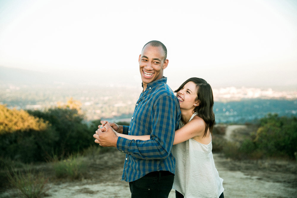 A young couple embracing on a hillside in los angeles.