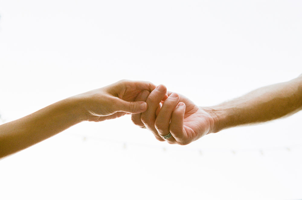 A man and woman holding each other's hands.