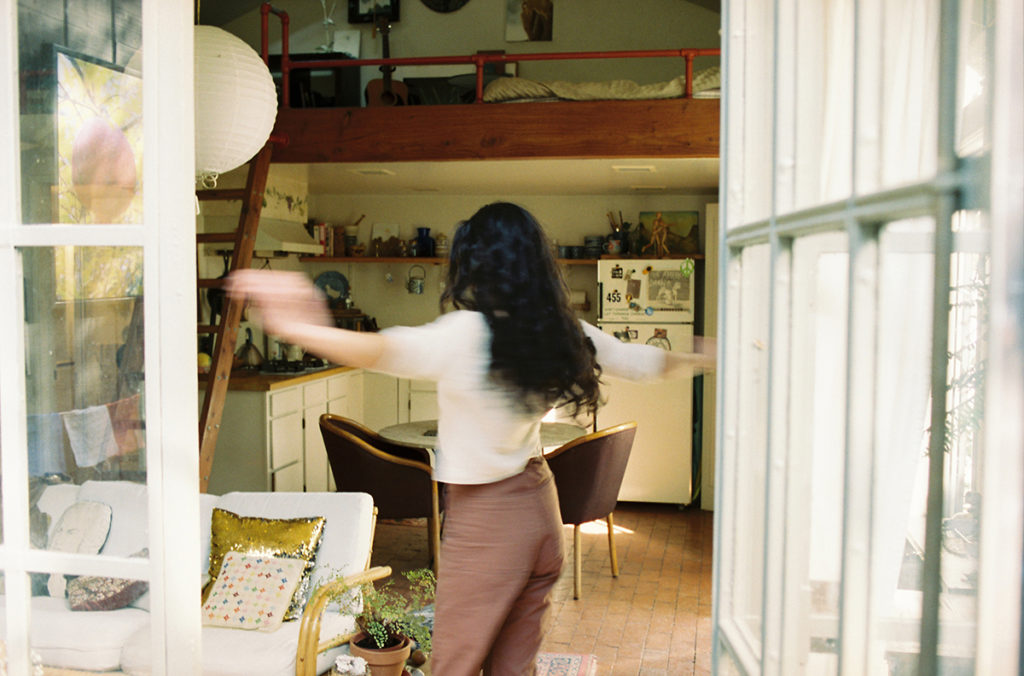 young woman spinning in house playfully