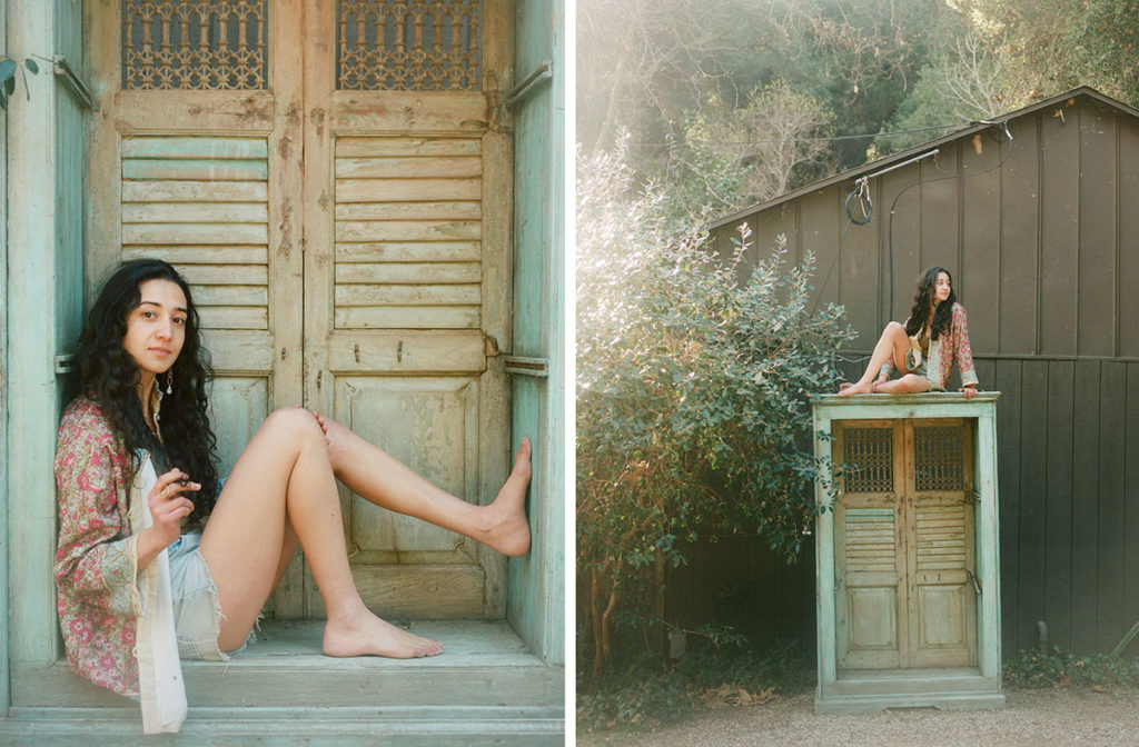 young free spirited woman sitting in a painted doorway