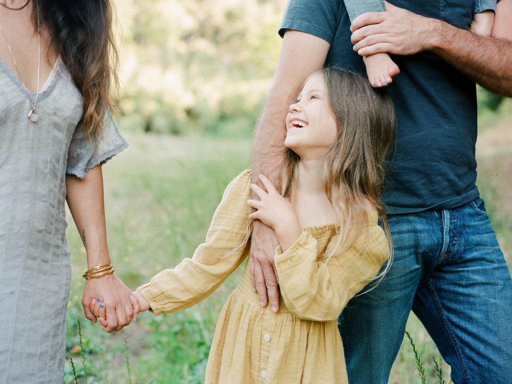 young girl smiling up at her mother