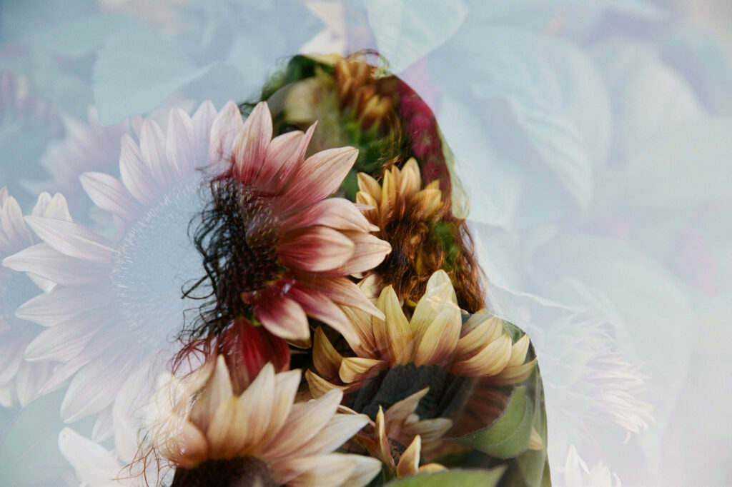double exposure film photograph of girl and sunflowers