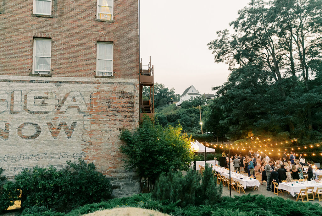 A wedding reception in front of a brick building.