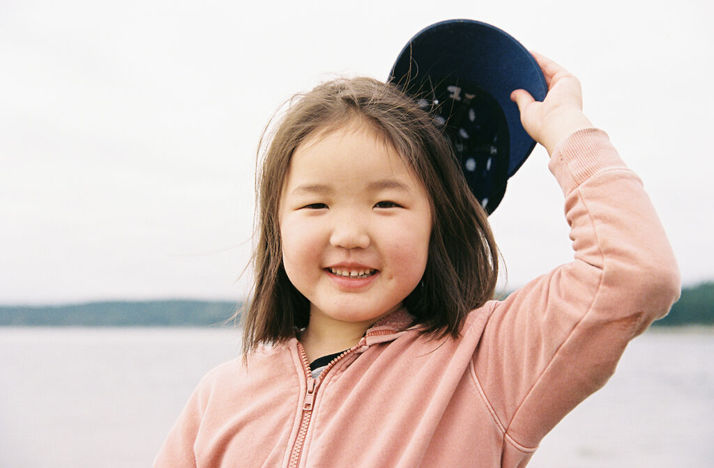 A little girl wearing a hat.