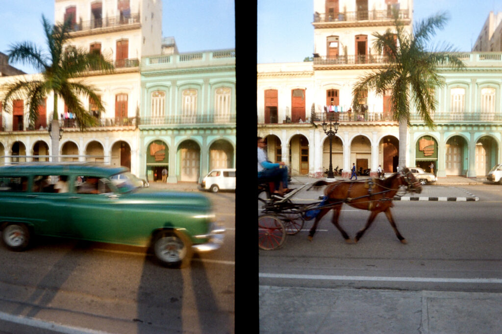 A split image showing a vintage car in motion on the left and a horse-drawn carriage on the right, against a backdrop of colorful colonial buildings.