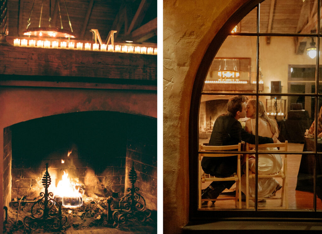 A couple sharing an intimate moment at a table by the window with a view of a cozy fireplace.