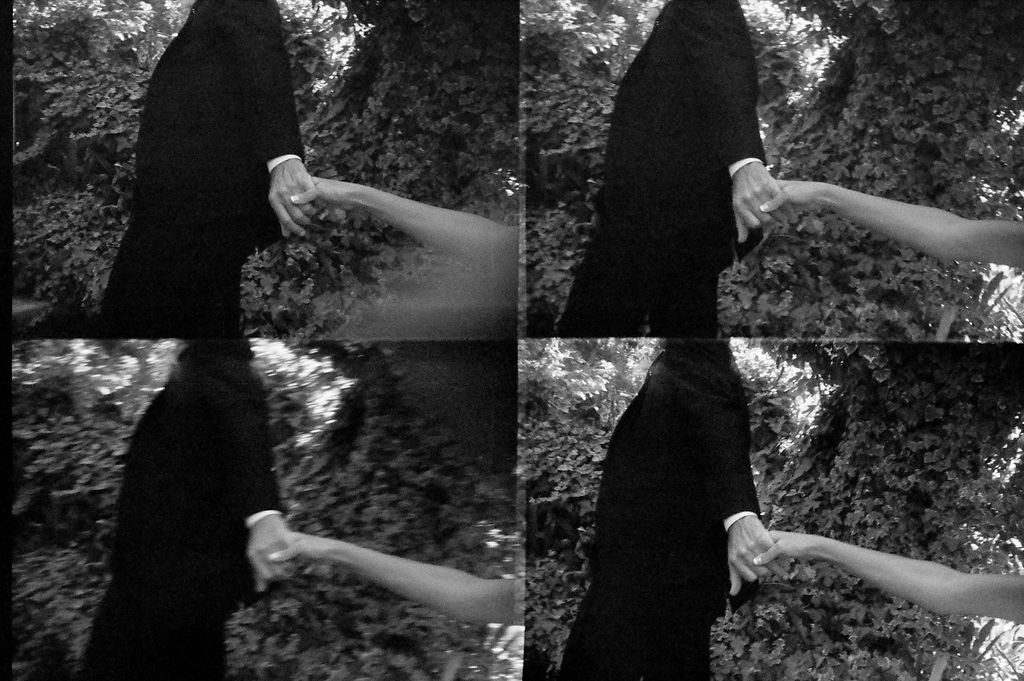 Four-panel sequence of two people holding hands while walking, shown in black and white.